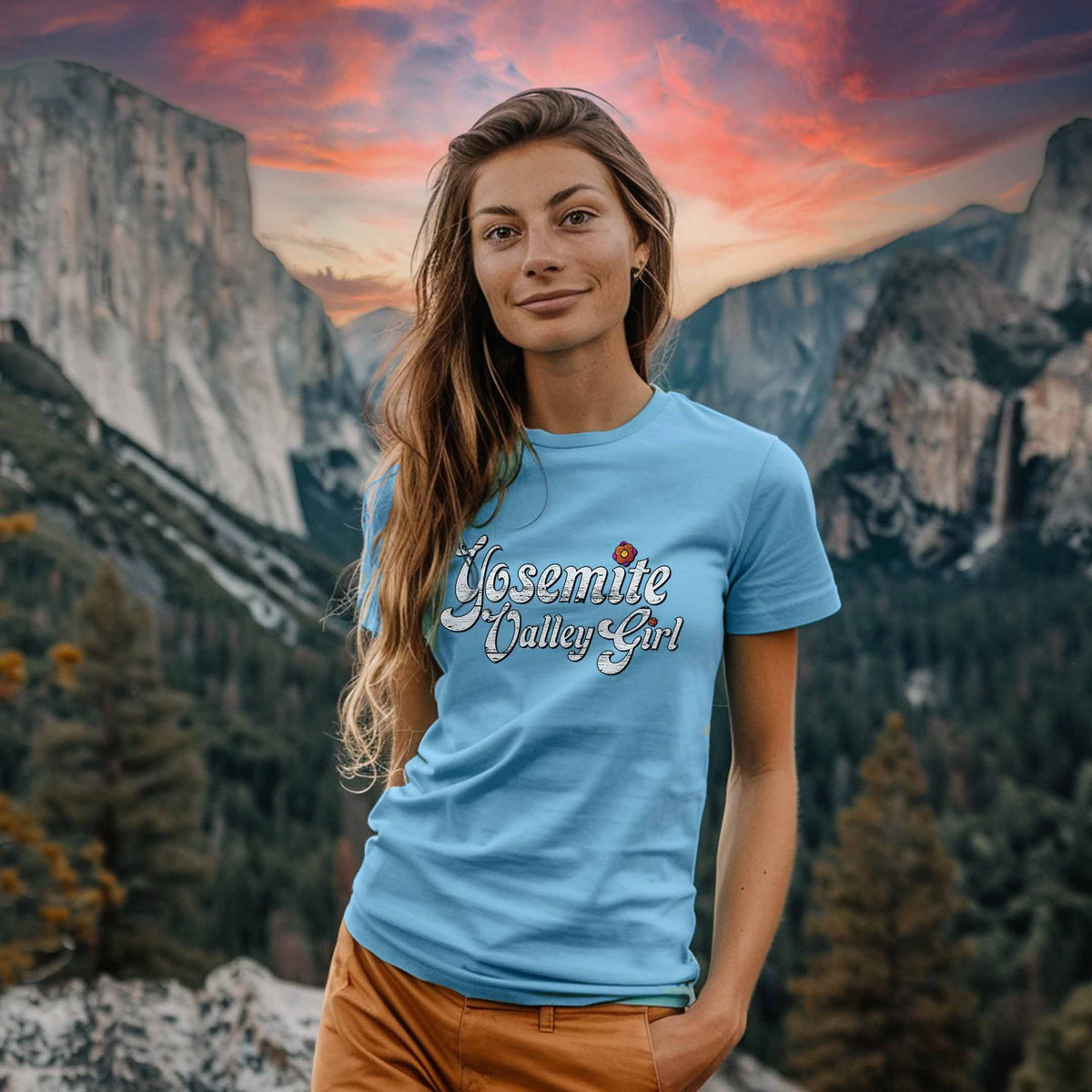 A woman wearing a light blue shirt that says "Yosemite Valley Girl" against Yosemite National Park in the background